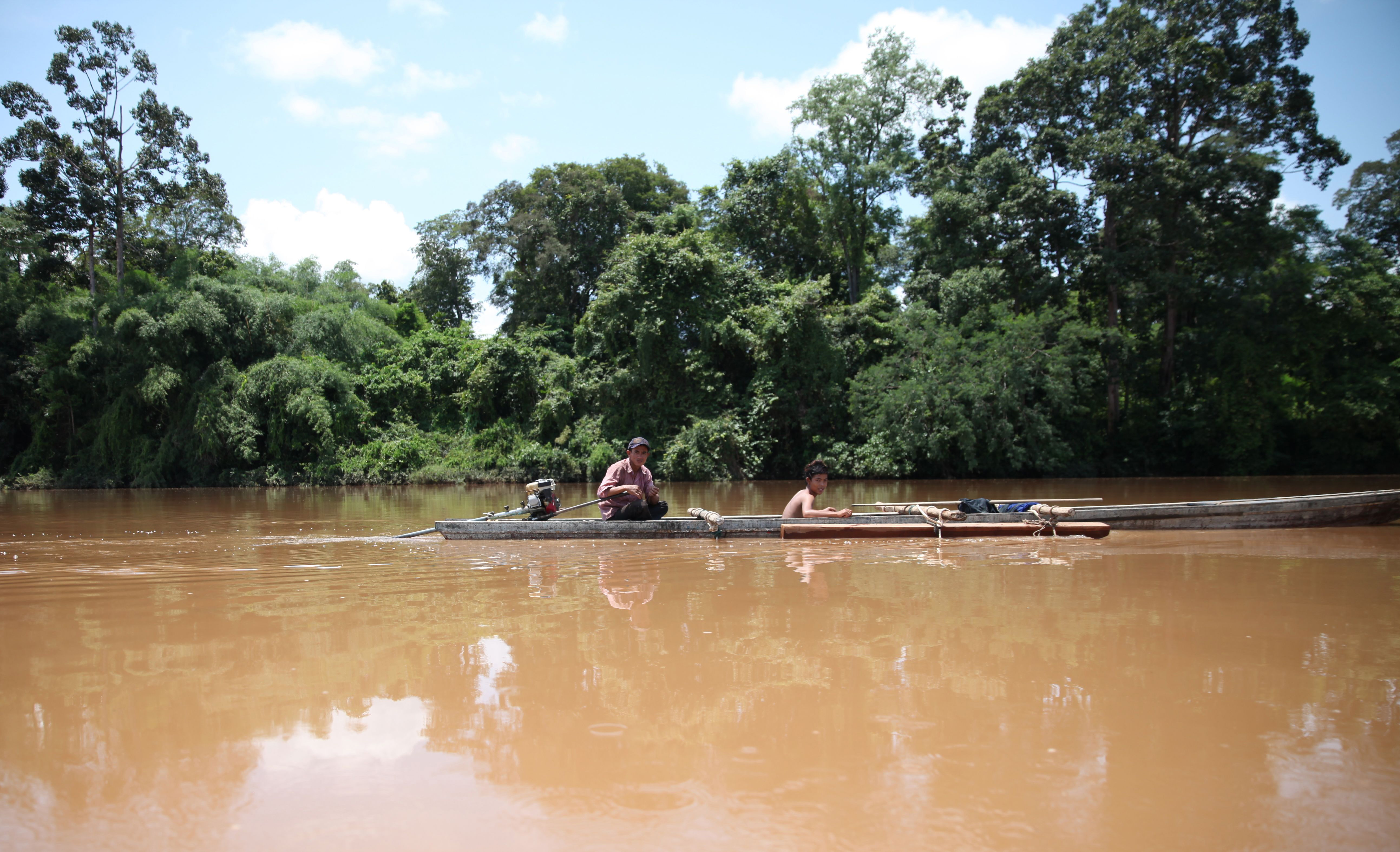 A boat transports timbre on the Sesan River in northern Cambodia [Thin Lei Win/Thomson Reuters Foundation]