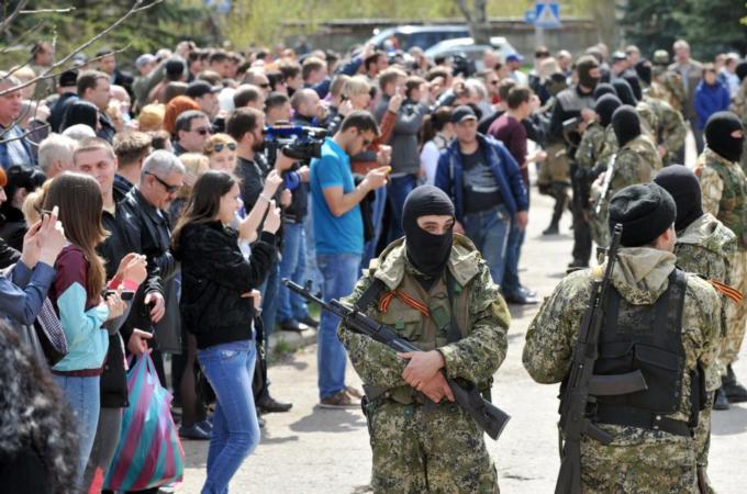 Residents are seemingly not worried by the presence of local militia units carrying semi-automatic weapons [AFP]