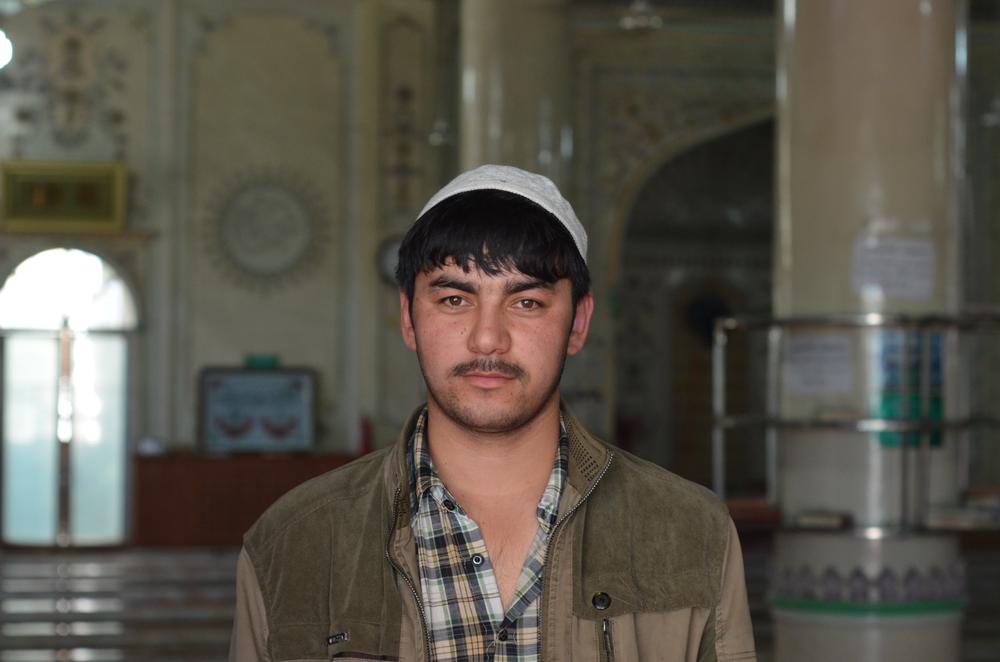 <p>A 20-year-old Uyghur man poses in an Urumqi mosque. He acts as the assistant to the mosque(***)s main imam. He and his boss are enthusiastic as they give an impromptu tour of their place of worship. There are five security cameras set up in the main chamber.</p>