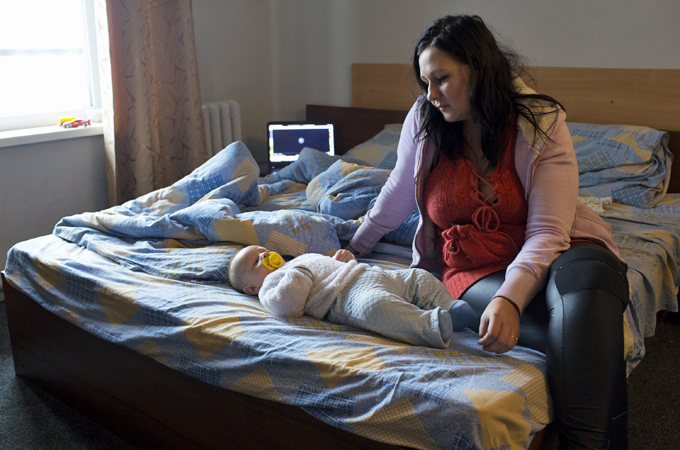 Widow Renata Proshunina takes care of her son, Emin, at the Katerina Hotel [John Wendle/Al Jazeera]
