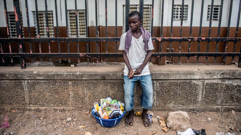Idrissa Kamara wants to be a doctor, but had to leave school and find work to help pay his way [Tommy Trenchard/Al Jazeera] 