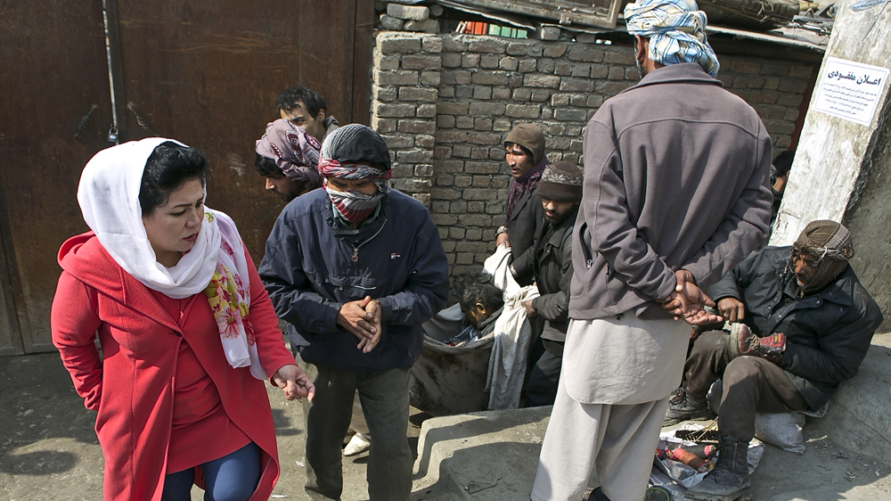 Afghan film-maker Laila Haidari helps heroin addicts and arranges for bodies to be taken away [Steve Chao/Al Jazeera]