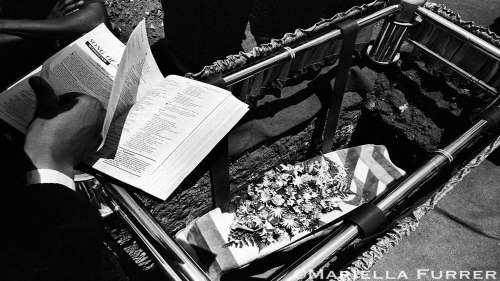 The funeral for three-year-old Sibongile Mokoena, who was raped and murdered on November 8, 2003. A 23-year-old family acquaintance was arrested. Due to Mokoena's family's lack of funds, a local funeral home donated the casket and paid for the funeral. Johannesburg, 2003 [Mariella Furrer]