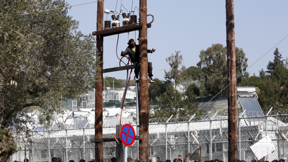 The man was convinced to come down after the intervention by police [Giorgos Moutafis/Reuters]