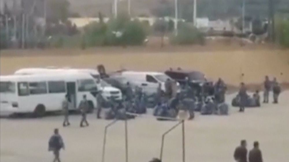 A still image taken from a video uploaded on a social media website shows what it says are government security forces walking outside Hama prison