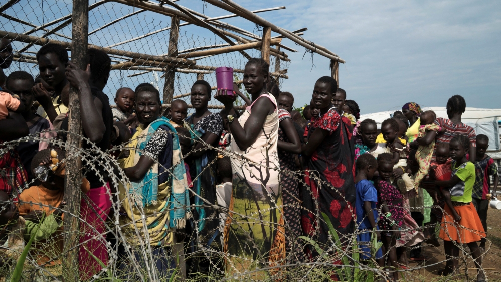 Women and children queue to receive emergency food at the U.N. protection of civilians site 3 hosting about 30,000 people displaced during the recent fighting in Juba