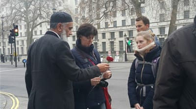 A member of the As-Siraat organisation hands out roses [Tasnim Nazeer/Al Jazeera]