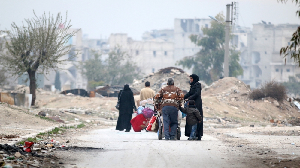 People carry their belongings as they flee Kadi Askar area towards Bustan al-Qasr neighbourhood, in rebel-held besieged Kadi Askar area of Aleppo