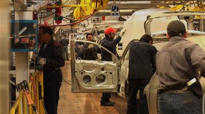 Mexican workers build cars on an assembly line inside a Volkswagen factory in the southern-central Mexican state of Puebla [Screengrab/Al Jazeera]