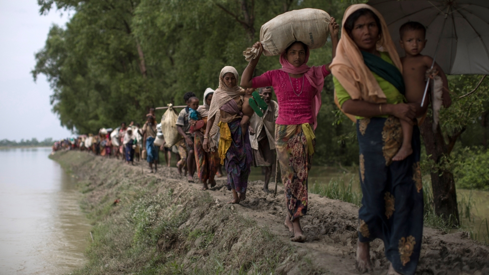 Rohingya Muslim refugees make their way into Bangladesh after crossing the Myanmar Bangladesh border [Dan Kitwood/Getty Images]Rohingya refugees sit as they are temporarily held by the Border Guard Bangladesh (BGB) in an open area after crossing the border in Teknaf, Bangladesh [Mohammad Ponir Hossain/Reuters]