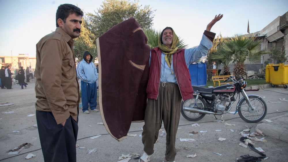 A man reacts following the earthquake in Sarpol-e Zahab county in Kermanshah, Iran [Tasnim News Agency/Reuters]