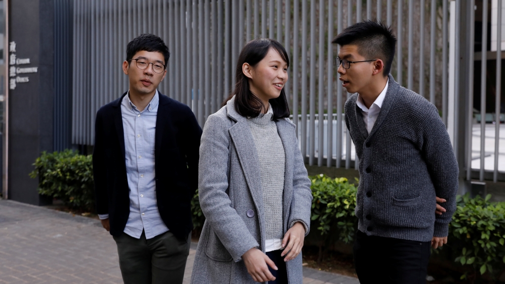 Disqualified lawmaker Nathan Law, and student activists Agnes Chow and Joshua Wong react outside Central Government Offices in Hong Kong