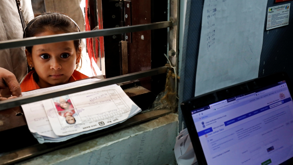 A girl waits for her turn to enrol for the Unique Identification database system, also known as Aadhaar, at a registration centre in New Delhi