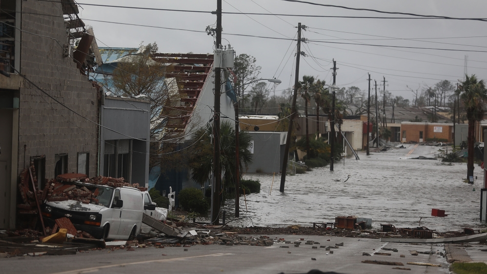 Damaged buildings and a flooded street are seen after hurricane Michael passed through the downtown Panama City, Florida [Joe Raedle/Getty Images/AFP]