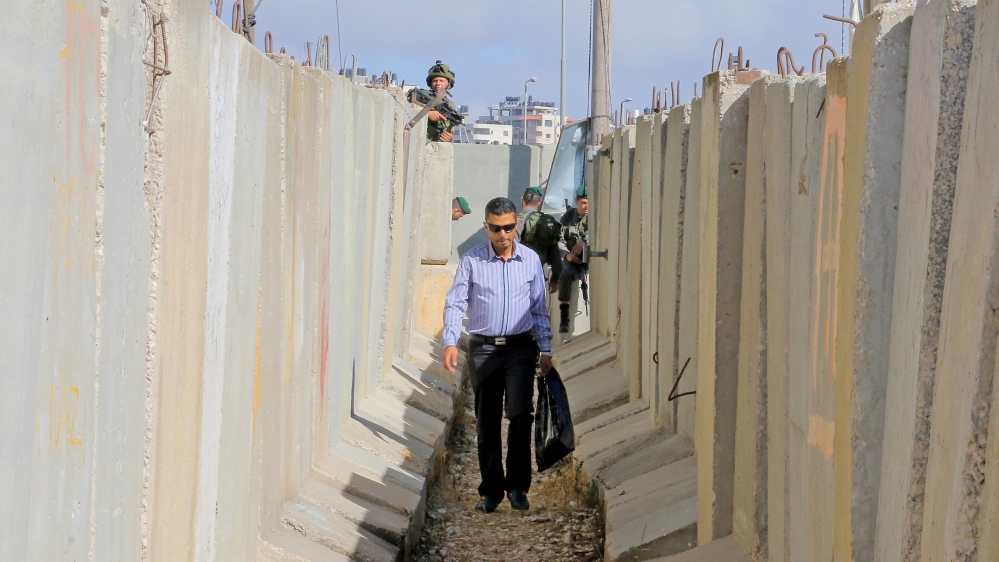 A Palestinian man walks away after not being permitted to cross the Qalandiya checkpoint, a main crossing point between Jerusalem and the West Bank city of Ramallah. Thousands of Palestinians headed to Jerusalem's Al-Aqsa mosque for the first Friday prayer of the holy Muslim fasting month of Ramadan on June 10, 2016 [Ahmad Al-Bazz/Activestills/Al Jazeera]