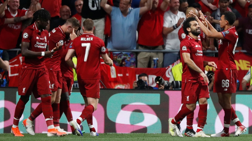 Liverpool’s Divock Origi celebrates scoring their second goal with James Milner, Mohamed Salah and teammates