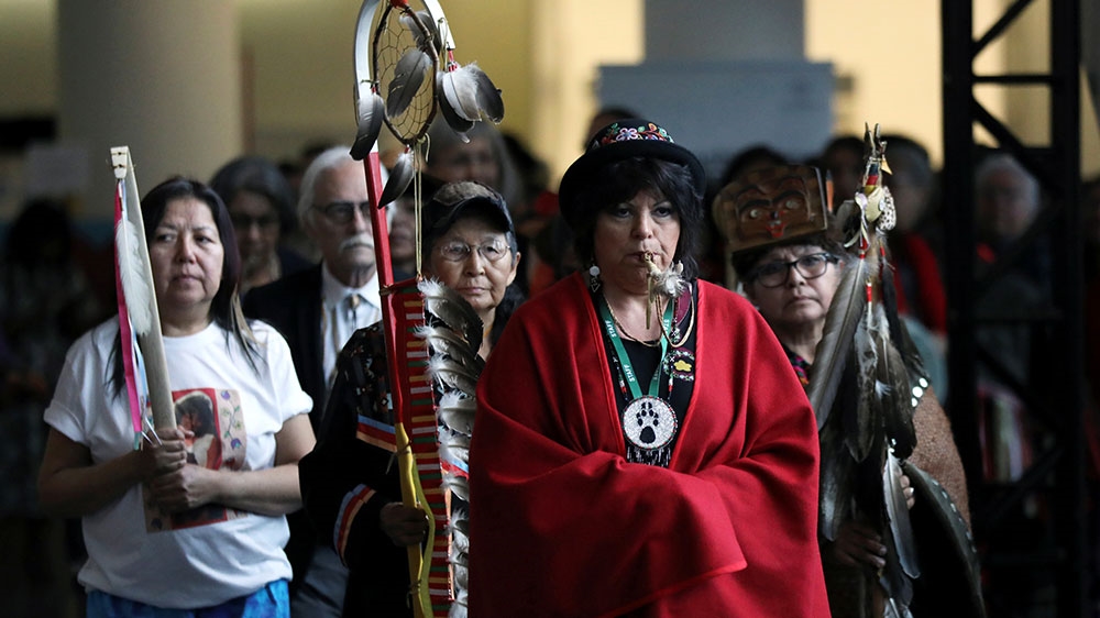 Women march in during the closing ceremony of the National Inquiry into Missing and Murdered Indigenous Women and Girls in Gatineau, Quebec, Canada
