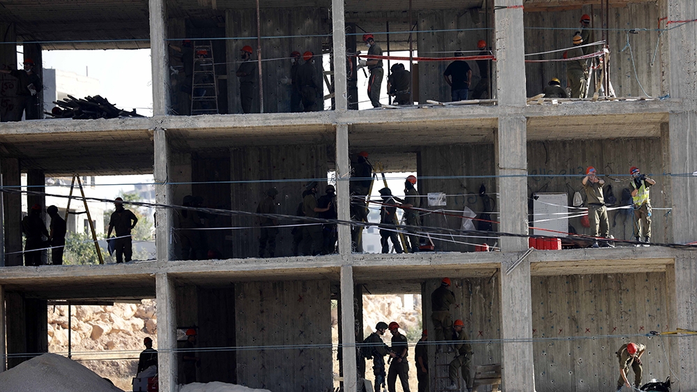 Israeli army troops set explosives in a building in the Palestinian village of Sur Baher, in East Jerusalem, 22 July 2019. Israeli authorities decided to demolish at least six Palestinian residential 