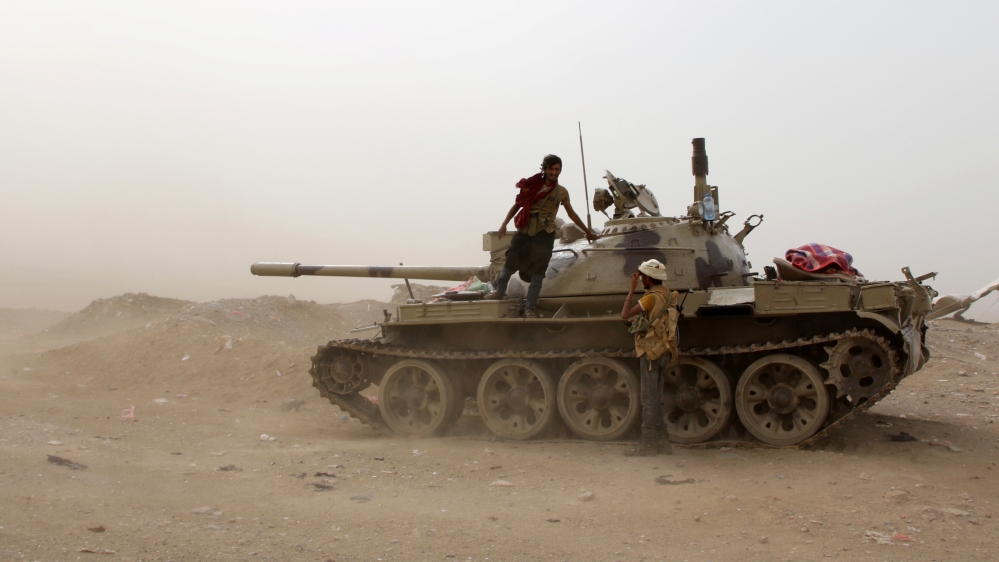 Members of the UAE-backed southern Yemeni separatist forces stand by a tank during clashes with government forces in Aden