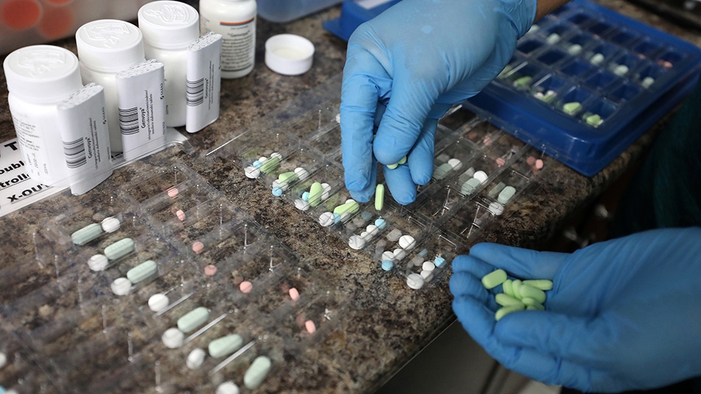 Pharmacist counting prescription drugs in Ottawa, Canada