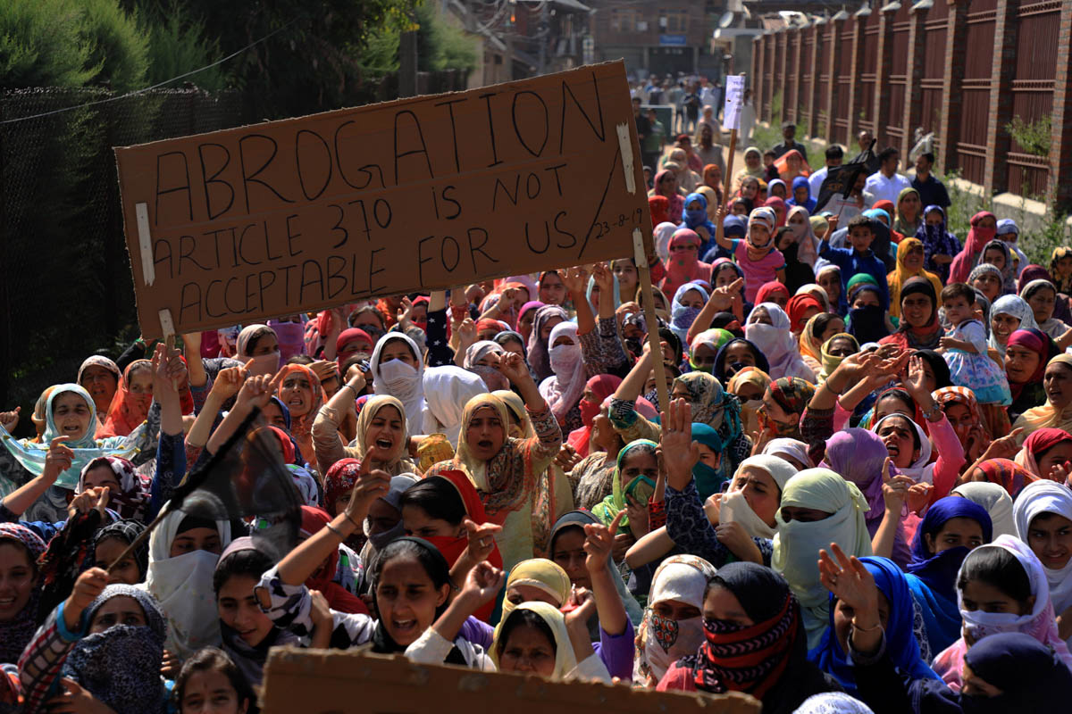 Kashmiri women holding placards shout pro-freedom slogans as they take part in a protest march after Friday prayers in soura Srinagar on august 23,