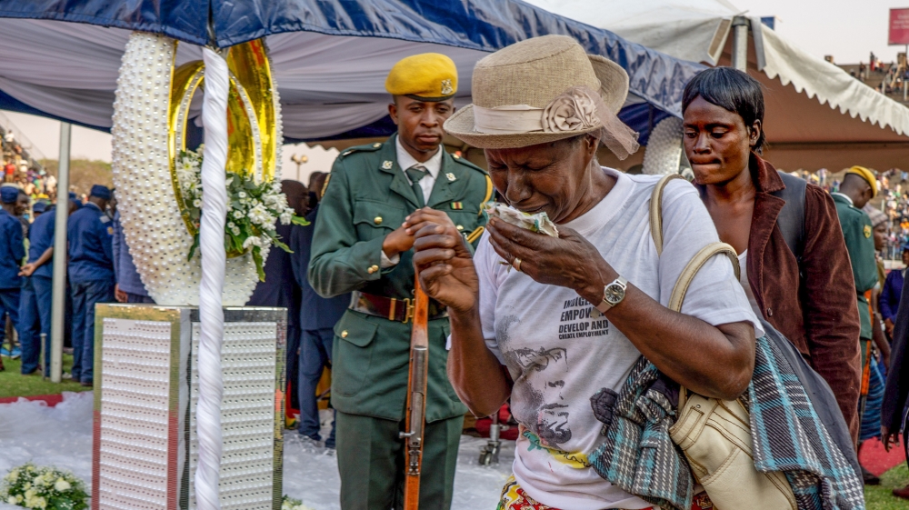 A woman weeps as she walks away from the coffin of the late former President Robert Mugabe held for public viewing at Rufaro Stadium in Mbare, Harare.