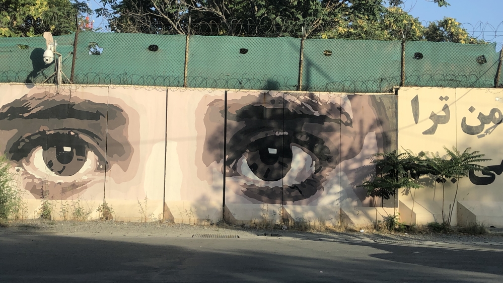 A pair of eyes, painted on a mural on the National Directorate of Security’s wall, looks on to the streets of downtown Kabul