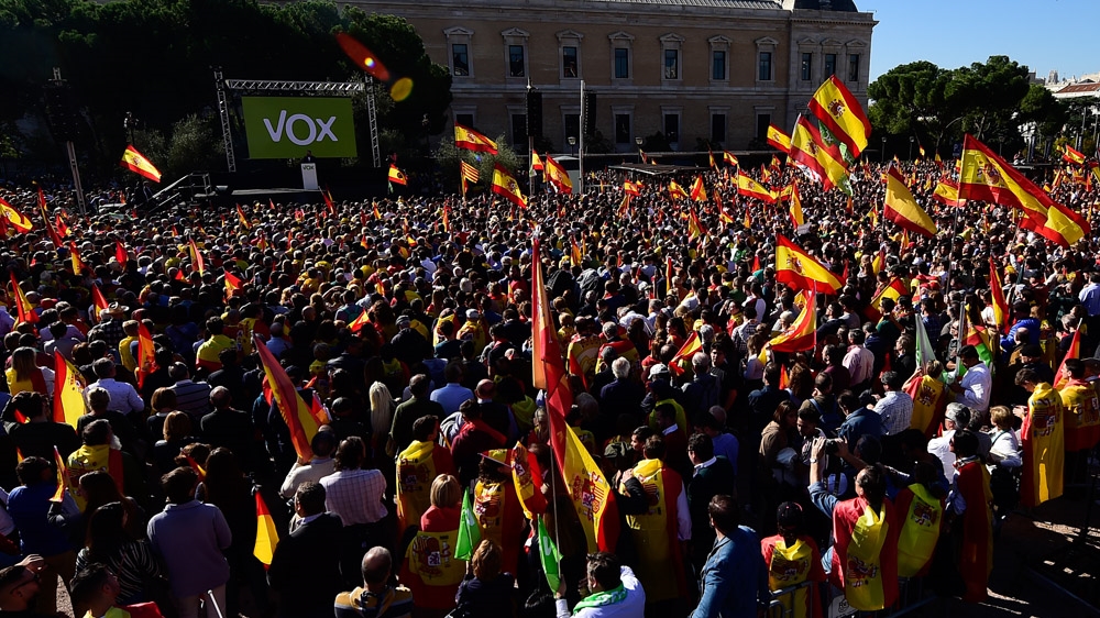 Supporters wave Spanish flags during a demonstration called by Spanish far-right Vox party, on Plaza de Colon square in Madrid