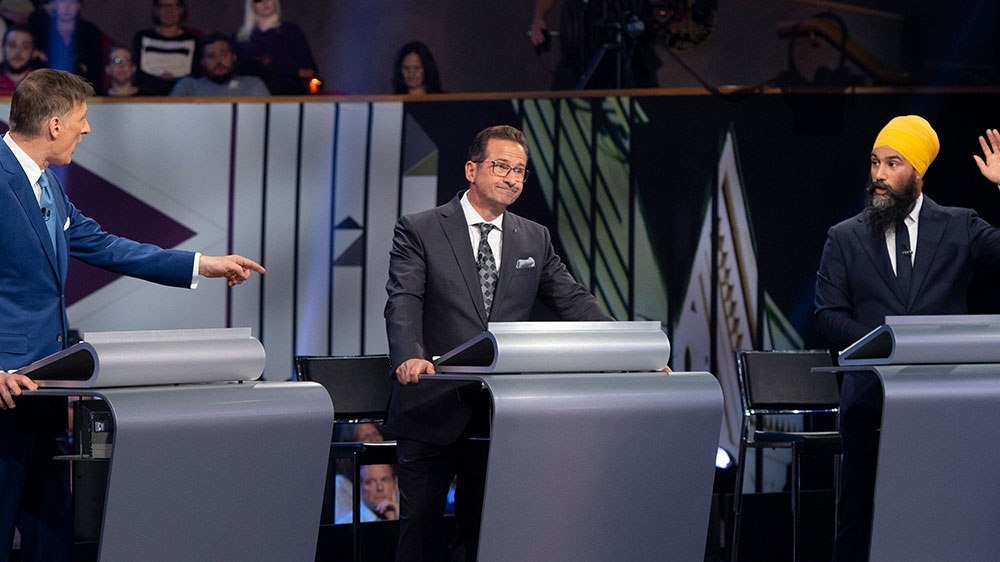 Bloc Quebecois leader Yves-Francois Blanchet (centre) listens to NDP leader Jagmeet Singh (right) and People’s Party of Canada leader Maxime Bernier speak during the Federal Leaders Debate