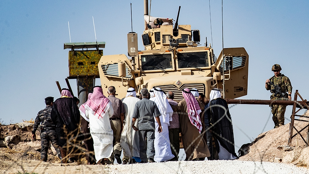 Syrian Kurds take part in a demonstration against Turkish threats at a US-led international coalition base on the outskirts of Ras al-Ain town in Syria''s Hasakeh province near the Turkish border on Oc