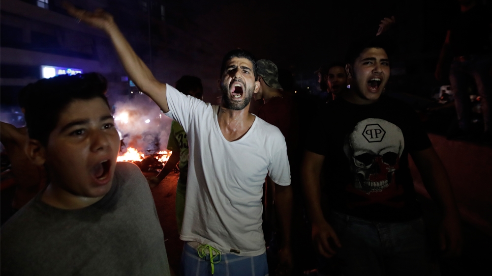 LEBANON-INTERNET-BUDGET-DEMO Lebanese demonstrators chant slogans during a protest against recent tax calls on October 17, 2019 in the southern suburbs of Beirut.