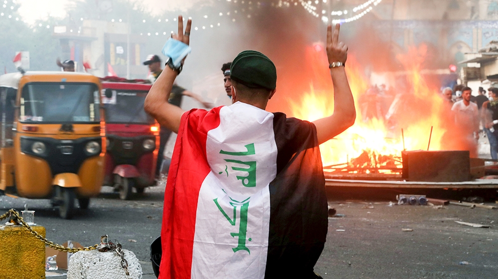 Anti-government protesters set fire and close streets during ongoing protests in Baghdad, Iraq, in central Baghdad, Iraq, Saturday, Nov. 9, 2019. (AP Photo/Hadi Mizban)