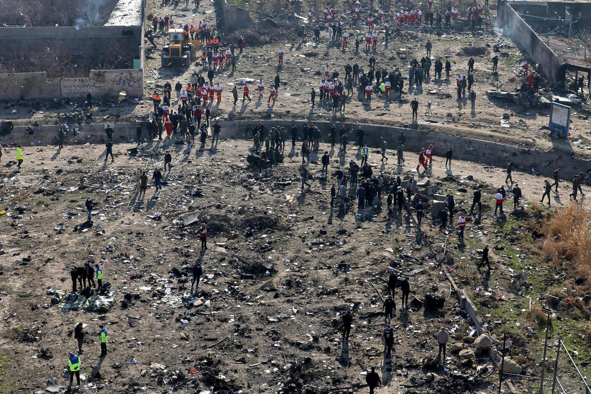 Rescue workers search the scene where a Ukrainian plane crashed in Shahedshahr southwest of the capital Tehran, Iran, Wednesday, Jan. 8, 2020. A Ukrainian airplane with more than 170 people crashed on