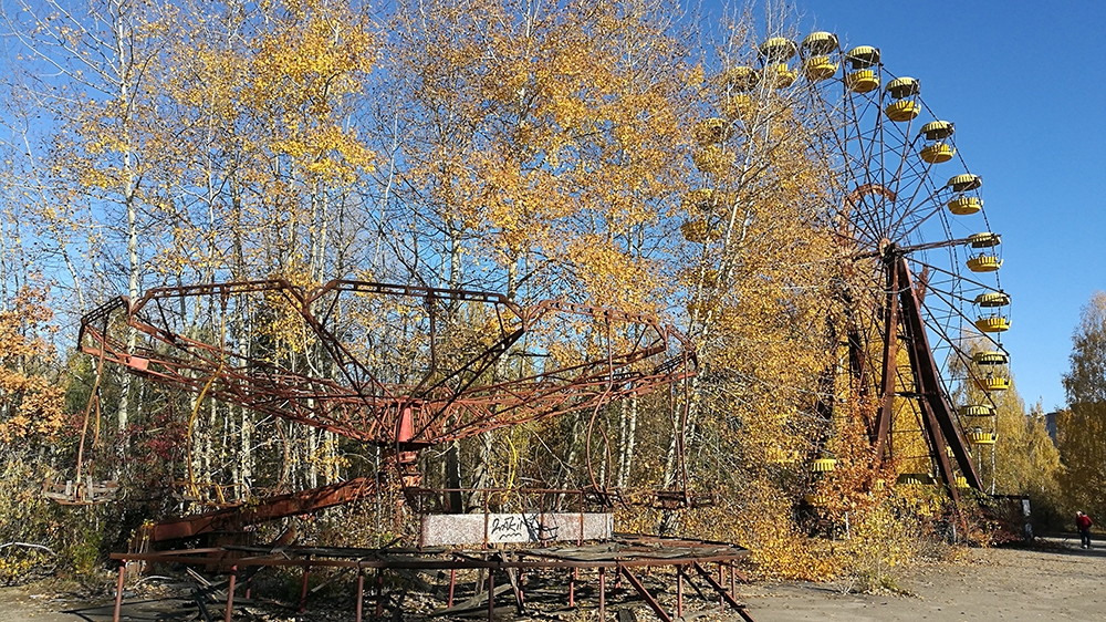 A merry-go-round and a Ferris wheel in the abandoned town of Pripyat