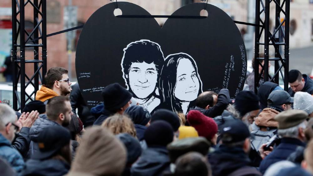 Demonstrators take part in a protest rally marking the second anniversary of the murders of investigative reporter Jan Kuciak and his fiancee Martina Kusnirova