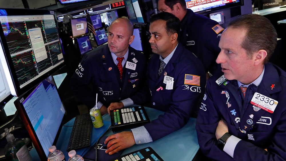 Specialists Mario Picone, Dilip Patel and Glenn Carrel, left to right, work on the floor of the New York Stock Exchange, Tuesday, Feb. 25, 2020. US stocks fell in midday trading Tuesday, a day after the market’s biggest drop in two years, as traders worry that the spreading coronavirus will threaten global economic growth