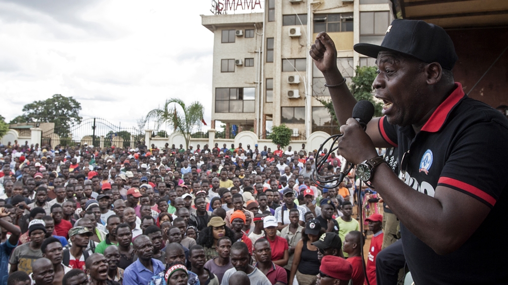 Executive Director at the Centre for Human Rights and Rehabilitation Timothy Mtambo (R) addresses protesters in Lilongwe on January 16, 2020, during a protest to denounce alleged