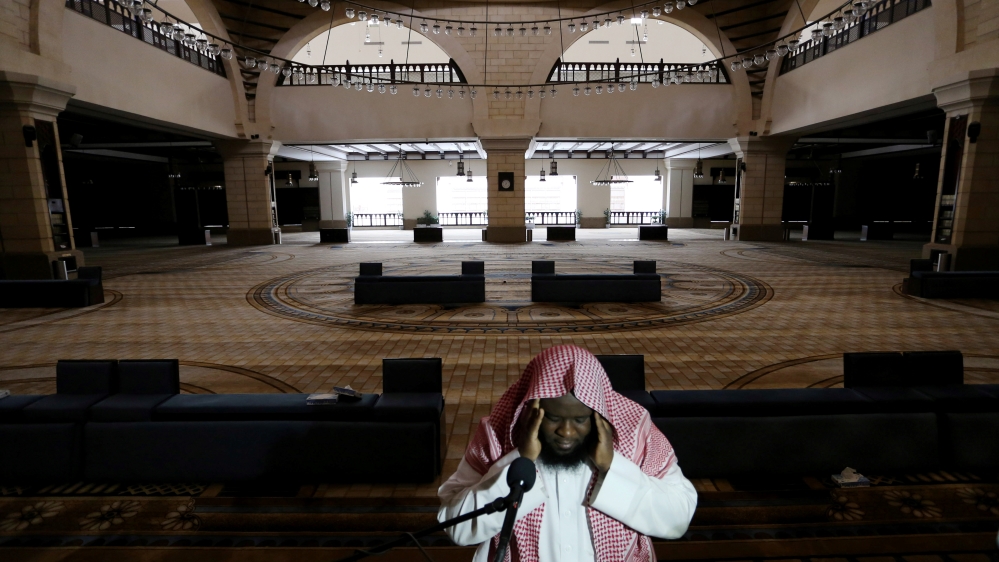 A cleric calls for the prayer at an empty Al-Rajhi Mosque, as Friday prayers were suspended following the spread of the coronavirus disease (COVID-19), in Riyadh