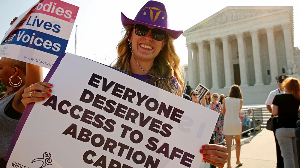 A demonstrator holds a sign outside the US Supreme Court as the court is set to rule on a legal challenge by abortion providers to a Texas law requiring doctors performing the procedure to have ‘admitting privileges’ at local hospitals and clinics to meet hospital-grade standards