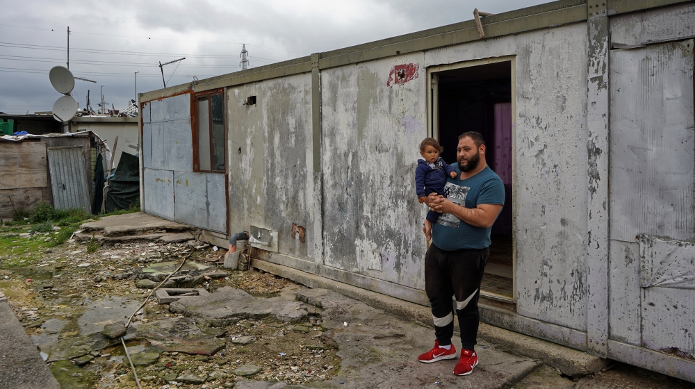 Zdravko Ahmetovic, 28, with his nephew, standing outside their home in Rome