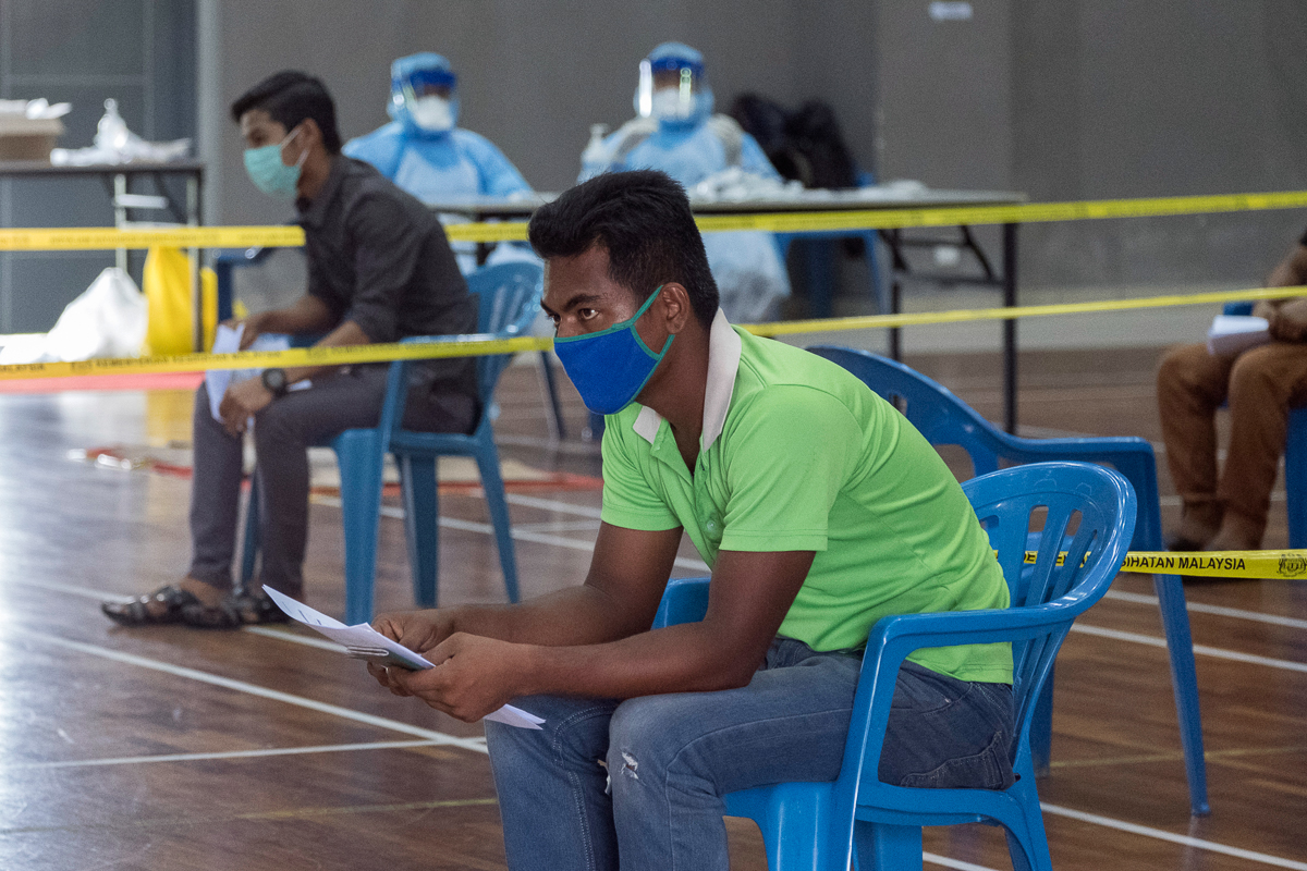 Rohingya refugees queue up at a Covid-19 temporary testing facility set up in a community centre at the outskirts of Kuala Lumpur. The testing is provided for free by the Malaysian Ministry of Health.