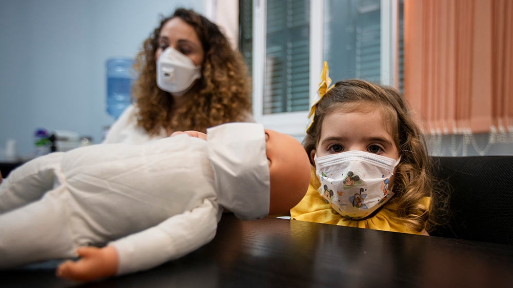 Vanesa Sanchez, a single mother and freelance journalist attends a work meeting while her daughter Valeria waits. Spain’s lockdown measures were among the strictest in Europe