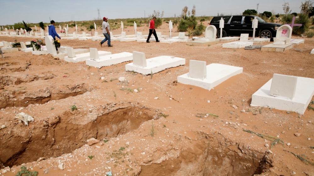 Gravediggers walk toward a hearse carrying the body of a woman, who died of COVID-19 before her funeral at a cemetery in Ciudad Juarez, Mexico, on May 8, 2020 REUTERS/Jose Luis Gonzalez [Reuters]