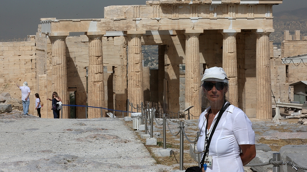 A guardian of antiquities stands on duty in the Acropolis archaeological site, in Athens, Greece