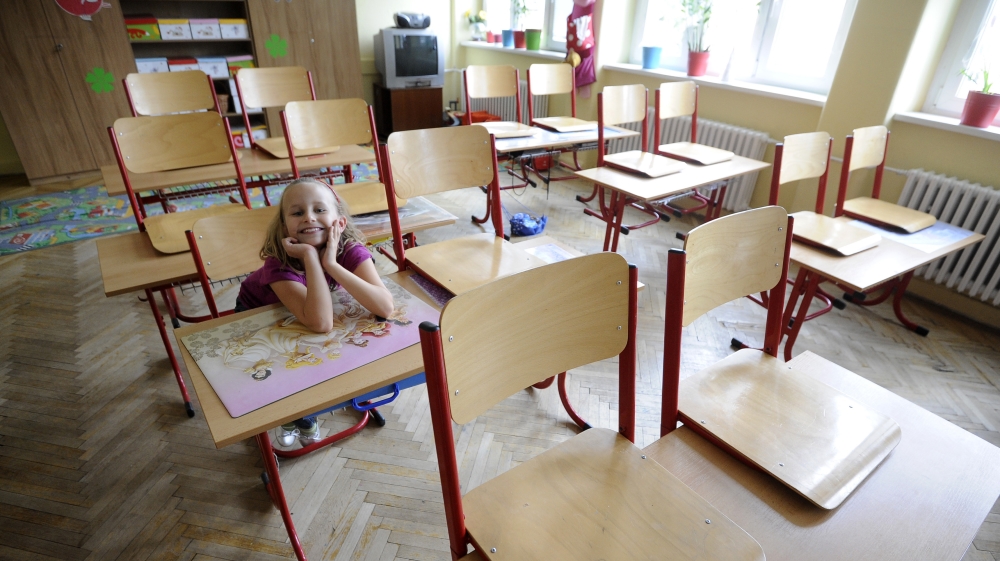 A primary school student Mia smiles inside a classroom in an empty school, closed during a one-day strike by local teachers, in Bratislava