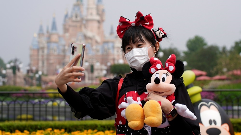 One of the first visitors to Shanghai Disneyland after the theme park reopened on Monday