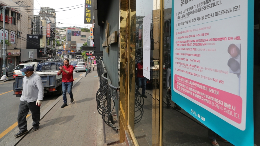 A list of precautions to prevent the spread of COVID-19 at the entrance of a club in Seoul, South Korea [Yonhap via Reuters]
