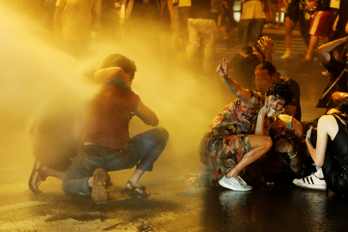 Police use water cannons as they clash with people during a protest against Israeli Prime Minister Benjamin Netanyahu and his government's response to the financial fallout of the coronavirus disease 