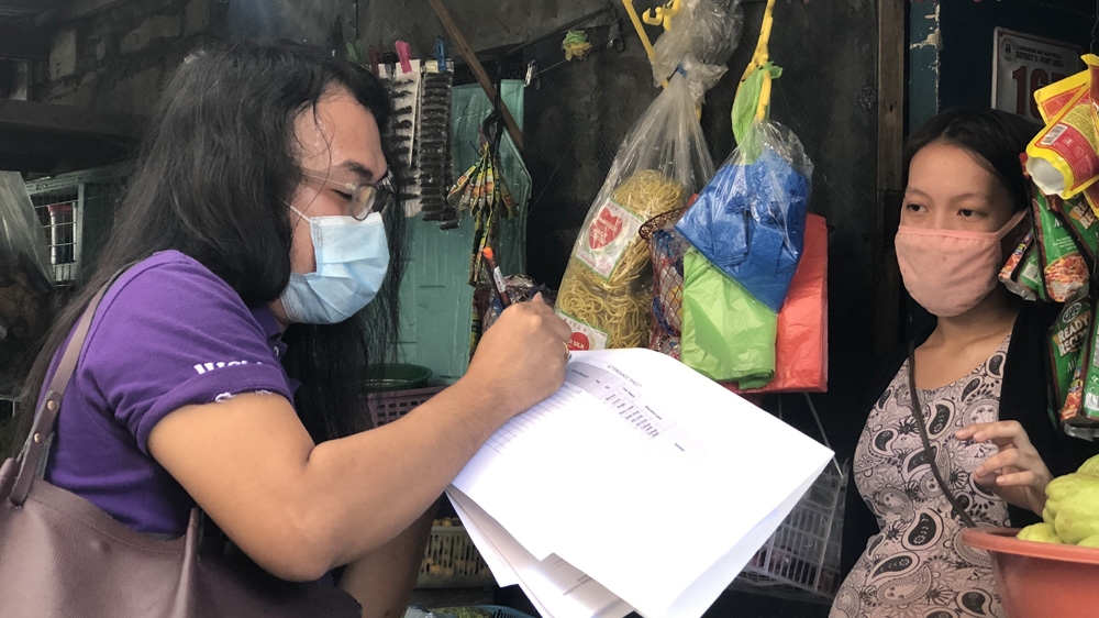 Health worker Mak Calsona does her rounds in Manila. Her work has been affected by the prolonged coronavirus lockdown
