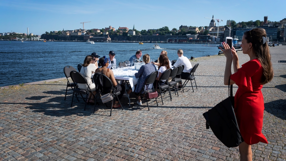 People have a drink after work while keeping a social distance due to the outbreak of the coronavirus disease (COVID-19), in Stockholm